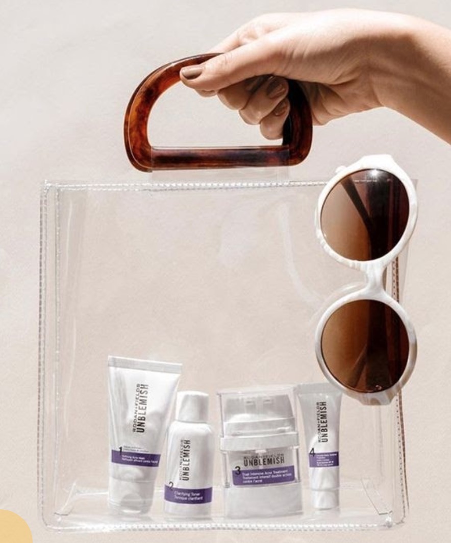 Clear tote bag filled with UNBLEMISH skin care products